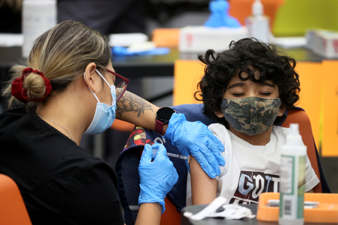 A 7-year-old child receives a COVID-19 vaccine in Chicago on Nov. 12, 2021. (Scott Olson/Getty Images)