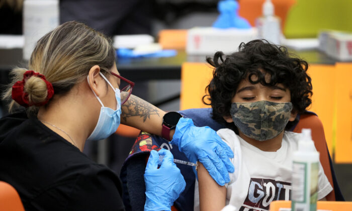 A 7-year-old child receives a COVID-19 vaccine in Chicago on Nov. 12, 2021. (Scott Olson/Getty Images)