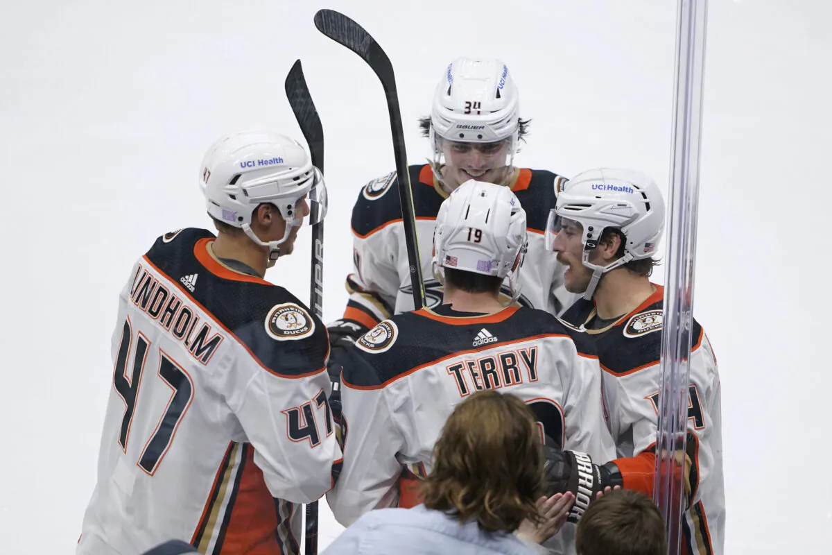 Anaheim Ducks right wing Troy Terry (19) is greeted by teammates after he scored a goal against the Seattle Kraken during the second period of an NHL hockey game, in Seattle, on Nov. 11, 2021. (Ted S. Warren/AP Photo)