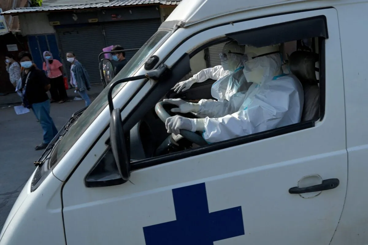 An ambulance transports a patient who tested positive for the COVID-19 to a hospital in Phnom Penh on May 3, 2021. (Tang Chhin Sothy/AFP via Getty Images)