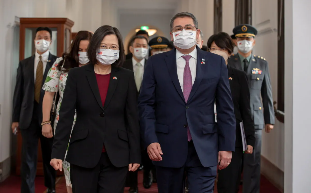 Taiwan President Tsai Ing-wen walks next to Honduran President Juan Orlando Hernandez, during their meeting in Taipei, Taiwan, on Nov. 13, 2021. (Taiwan Presidential Office/Handout via Reuters)