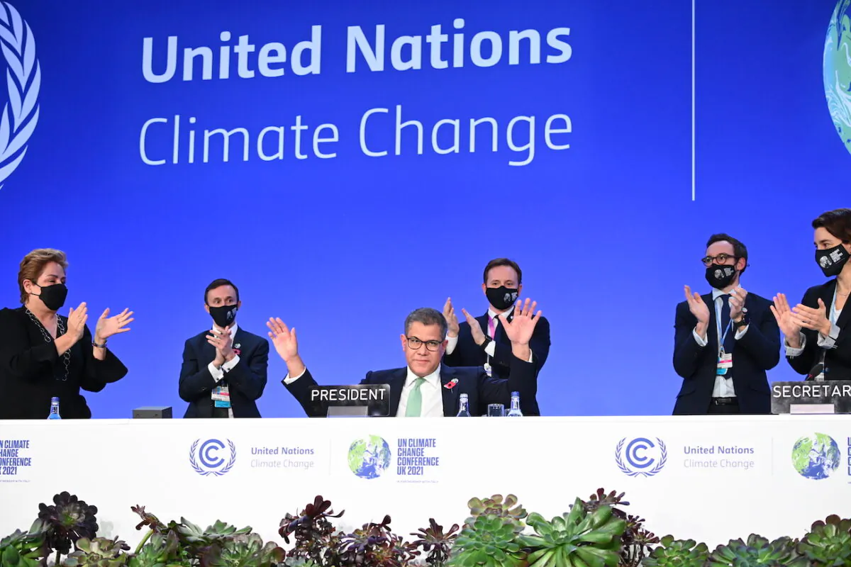 COP26 President Alok Sharma receives applause after giving the closing speech as he attends the Closing Plenary of the COP26 Climate Summit at SECC in Glasgow, Scotland, on Nov. 13, 2021. (Jeff J Mitchell/Getty Images)