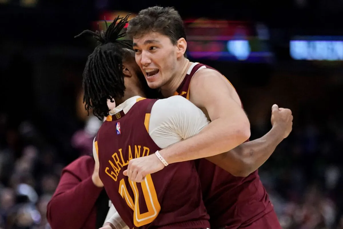 Cleveland Cavaliers' Cedi Osman, (R), hugs Darius Garland after the Cavaliers defeated the Boston Celtics 91–89 in an NBA basketball game in Cleveland, on Nov. 13, 2021. (Tony Dejak/AP Photo)