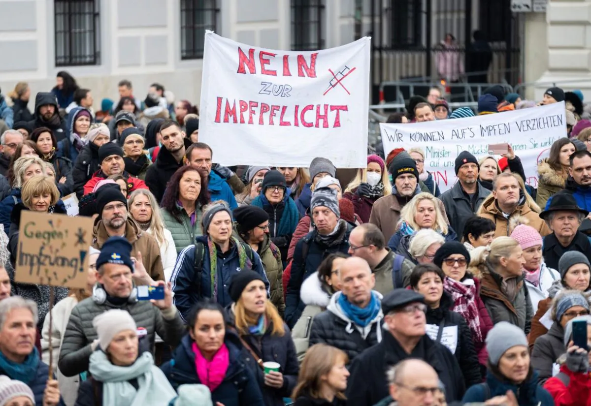 A demonstrator holds a placard reading, "No to compulsory vaccination," during a protest against COVID-19 vaccine lockdowns in Vienna, Austria, on Nov. 14, 2021. (Georg Hockmuth/APA/AFP via Getty Images)