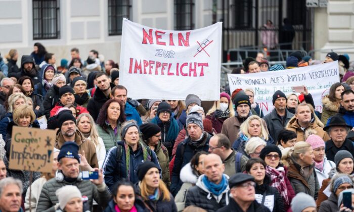 A demonstrator holds a placard reading, "No to compulsory vaccination," during a protest against COVID-19 vaccine lockdowns in Vienna, Austria, on Nov. 14, 2021. (Georg Hockmuth/APA/AFP via Getty Images)