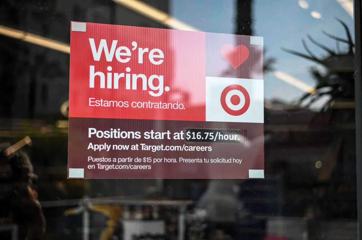 A sign advertising for new employees with an updated starting salary of $16.75 per hour is seen in the window of a Target store in Hollywood, Calif., on Nov. 9, 2021. (Robyn Beck/AFP via Getty Images)