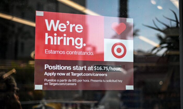 A sign advertising for new employees with an updated starting salary of $16.75 per hour is seen in the window of a Target store in Hollywood, Calif., on Nov. 9, 2021. (Robyn Beck/AFP via Getty Images)