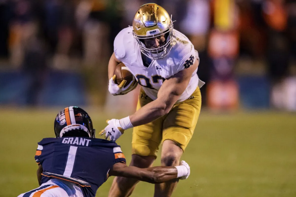Notre Dame tight end Michael Mayer (87) avoids Virginia cornerback Nick Grant (1) during the first half of an NCAA college football game, in Charlottesville, Va., on Nov. 13, 2021. (Mike Caudill/AP Photo)