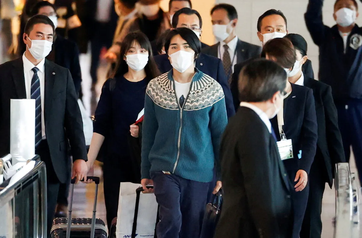 Mako Komuro, former Japanese Princess Mako and the eldest daughter of Crown Prince Akishino and Crown Princess Kiko, and her newly married husband, Kei, board a flight bound for New York, at Haneda airport in Tokyo, Japan, on Nov. 14, 2021. (Issei Kato/Reuters)