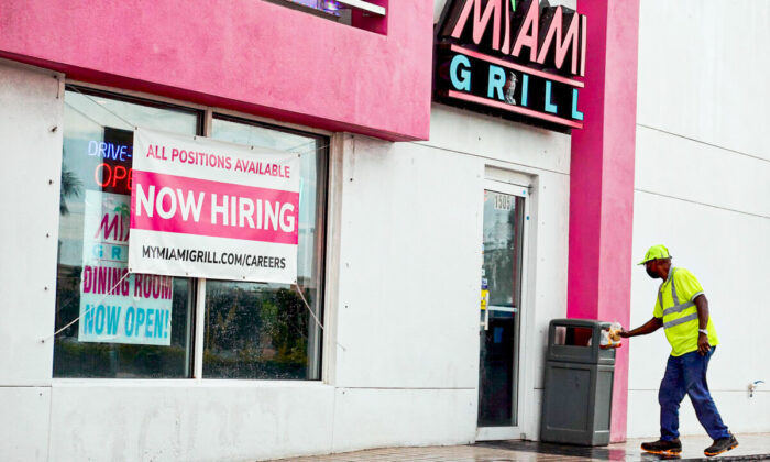 A "Now Hiring" sign near the entrance to a Miami Grill restaurant in Hallandale, Fla., on Sept. 21, 2021. (Photo by Joe Raedle/Getty Images)