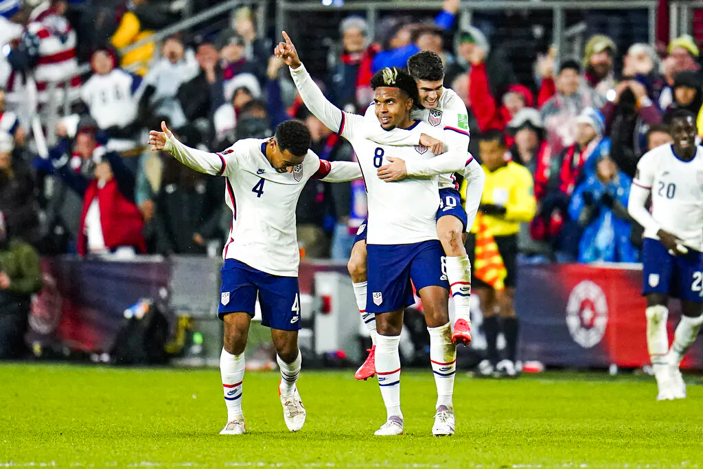 United States' Weston McKennie celebrates his goal with Tyler Adams, left, and Christian Pulisic during the second half of a FIFA World Cup qualifying soccer match against Mexico, Friday, Nov. 12, 2021, in Cincinnati. The U.S. won 2-0. (AP Photo/Julio Cortez)