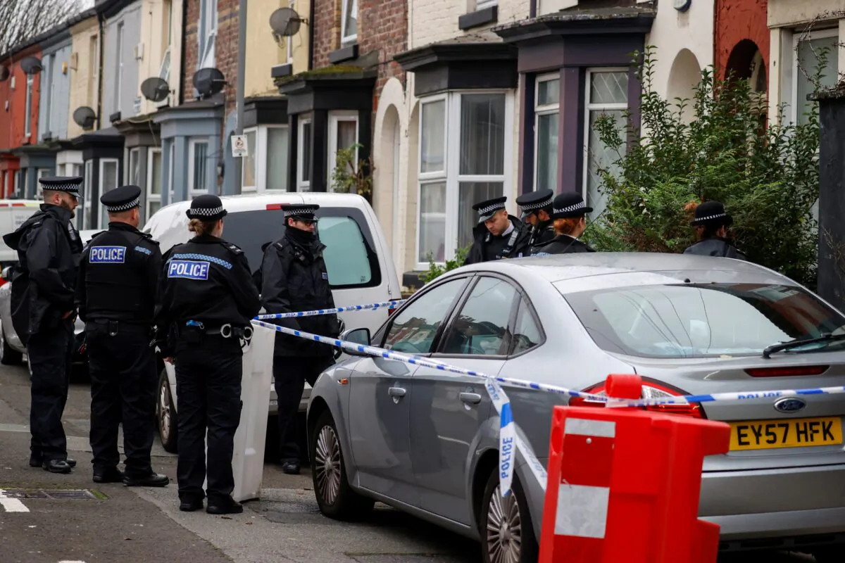Police officers keep guard outside a house in the Kensington area where counter-terrorism officers arrested men after a vehicle exploded outside Liverpool Women's Hospital in Liverpool, Britain, on Nov. 15, 2021. (Phil Noble/Reuters)