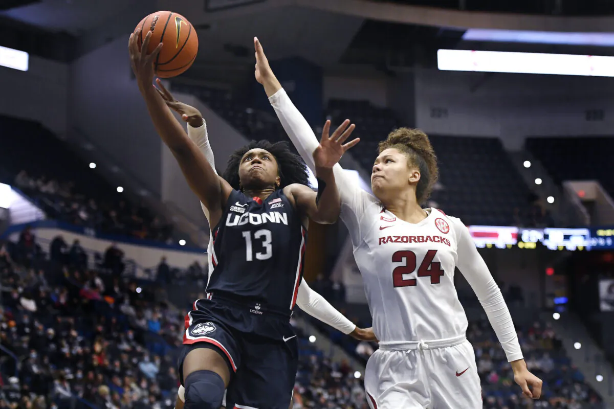 Arkansas' Jersey Wolfenbarger (24) fouls Connecticut's Christyn Williams in the second half of an NCAA college basketball game in Hartford, Conn., on Nov. 14, 2021. (Jessica Hill/AP Photo)
