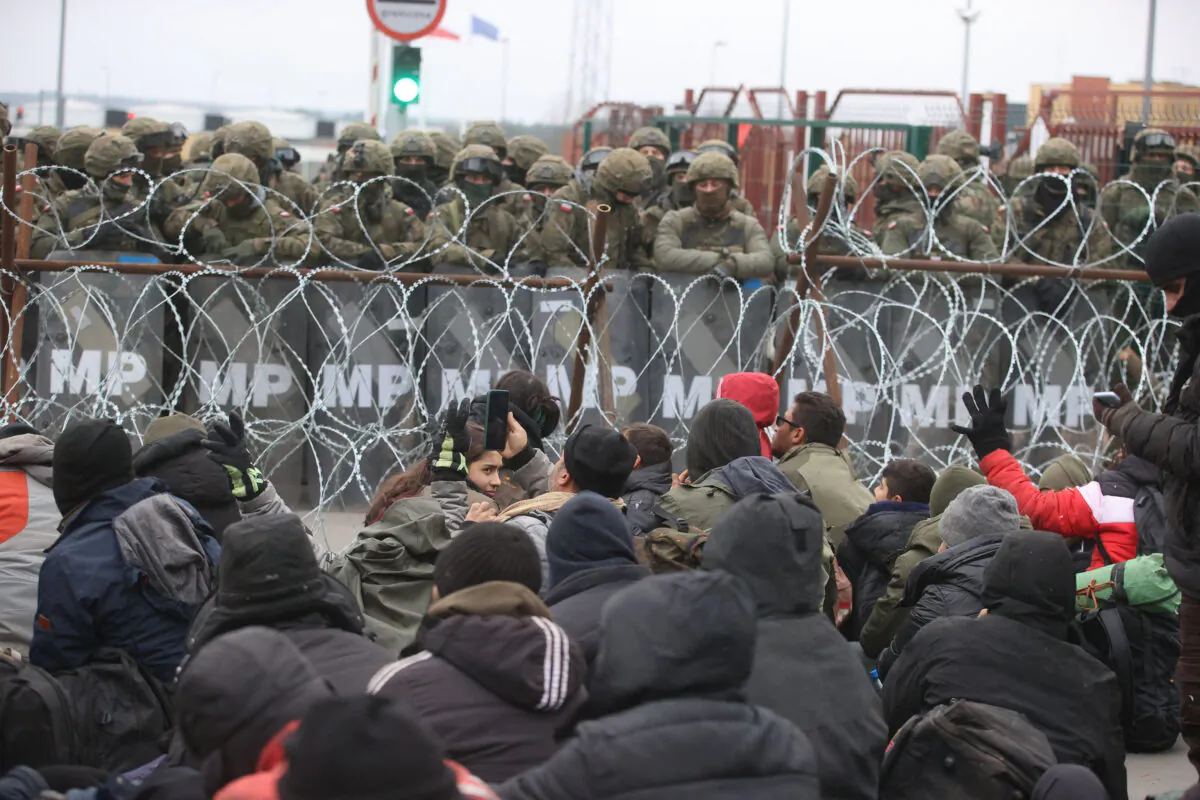 Illegal immigrants gather on the Belarusian–Polish border near the Polish Kuznica border crossing on Nov. 15, 2021. (Leonid Shcheglov/BELTA/AFP via Getty Images)