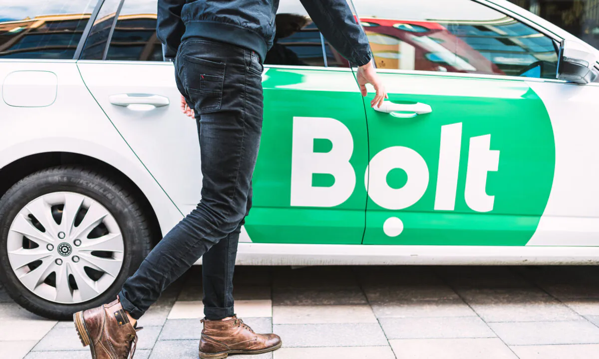 Undated photo showing a person walking toward a Bolt Minicab. (Bolt/PA)
