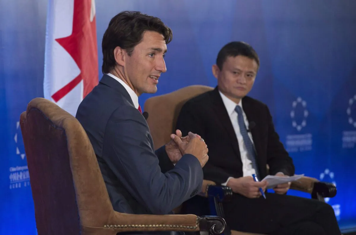 Prime Minister Justin Trudeau responds to a question as Chinese business magnate Jack Ma listens, during an event at the Chinese Entrepreneur Club in Beijing, China, on Aug. 30, 2016. (The Canadian Press/Adrian Wyld)