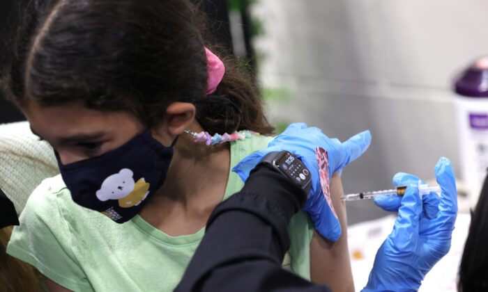 8-year-old Ava Onaissi receives a pediatric Pfizer COVID-19 vaccination during a vaccination clinic at Emmanuel Baptist Church in San Jose, Calif. on Nov. 3, 2021. (Justin Sullivan/Getty Images)