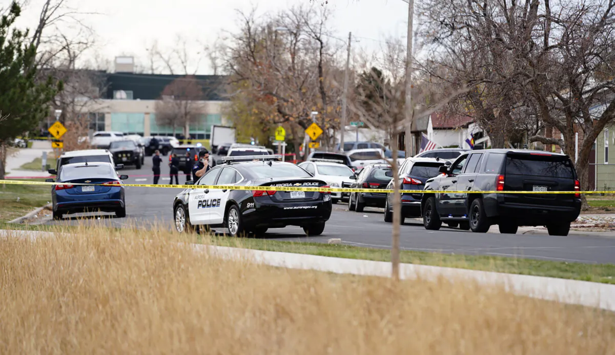 Law enforcement officials survey the scene of a shooting in which six teenagers were injured in a park, in Aurora, Colo., on Nov. 15, 2021. (Philip B. Poston/Sentinel Colorado via AP)
