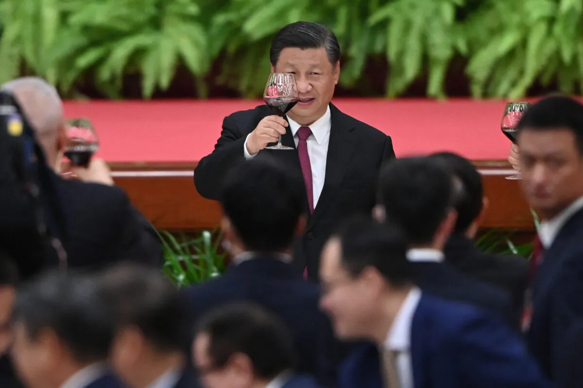 Chinese leader Xi Jinping raises his glass after a speech by Premier Li Keqiang at a reception at the Great Hall of the People in Beijing on Sept. 30, 2021. (Greg Baker/AFP via Getty Images)