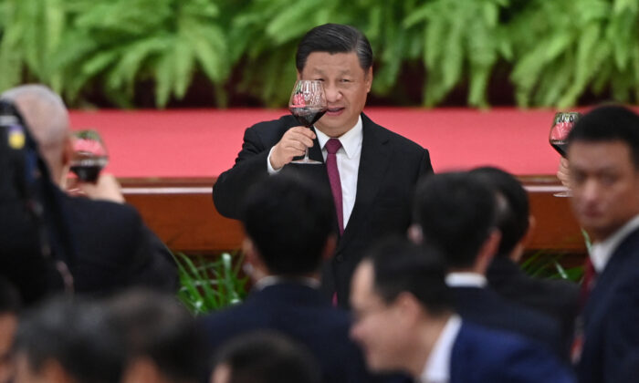 Chinese leader Xi Jinping raises his glass after a speech by Premier Li Keqiang at a reception at the Great Hall of the People in Beijing on Sept. 30, 2021. (Greg Baker/AFP via Getty Images)