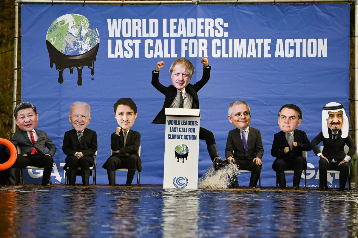 Activists dressed as world leaders demonstrate on a raft on the Forth and Clyde canal during the COP26 climate summit in Glasgow, Scotland, on Nov. 9, 2021. (Jeff J Mitchell/Getty Images)