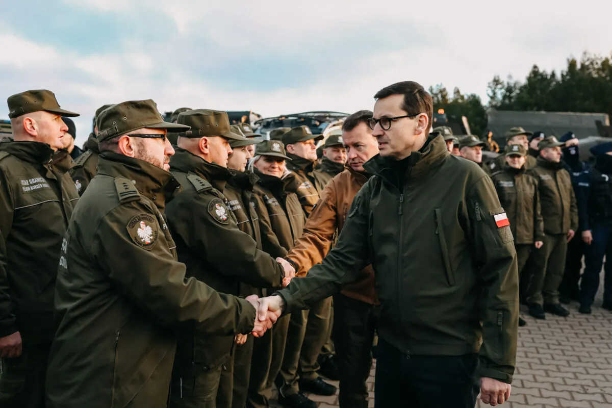 In this handout image provided by the Polish Ministry Of Defense, Polish Prime Minister Mateusz Morawiecki meets border army units at the Belarusian-Polish border as illegal immigrants gather on the border in Kuznica, Poland, on Nov. 9, 2021.  ( Polish Ministry Of Defense via Getty Images)