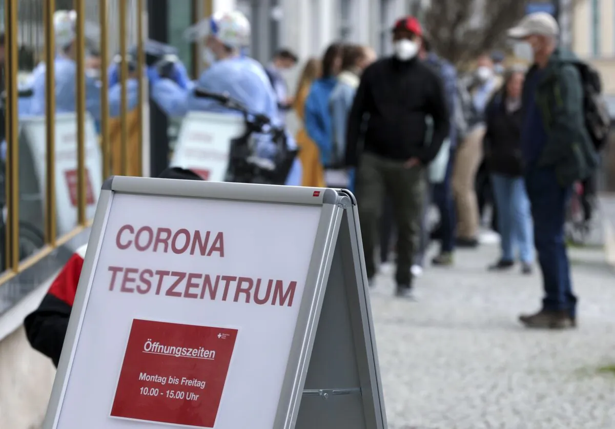 People outside a COVID-19 rapid test center waiting to get a day pass to visit shops and cultural institutions, in Weimar, Germany, on March 29, 2021. (Karina Hessland/Reuters)