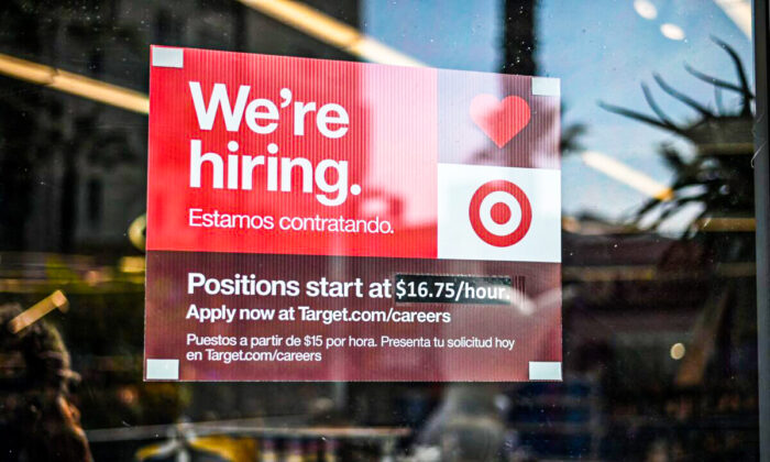 A sign advertising for new employees with an updated starting salary of $16.75 per hour is seen in the window of a Target store in Hollywood, Calif., on Nov. 9, 2021. (ROBYN BECK/AFP via Getty Images)