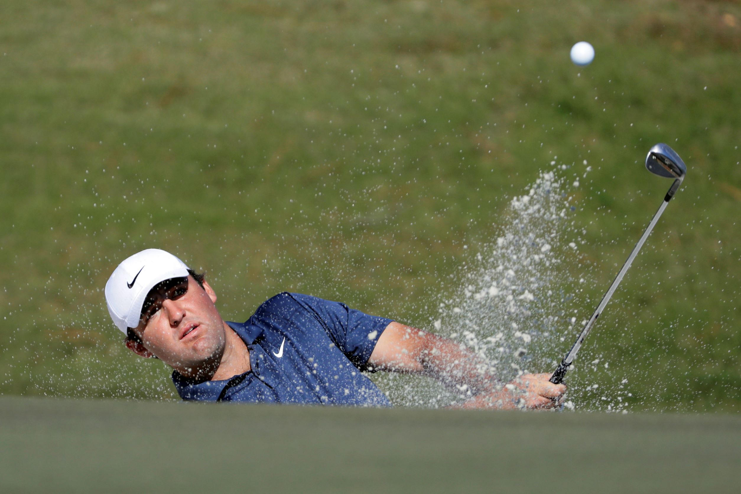 Scottie Scheffler hits out of a bunker