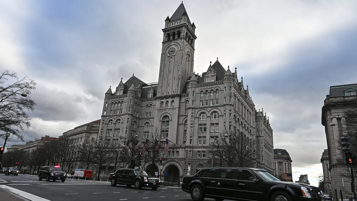 An official motorcade speeds down Pennsylvania Avenue past the International Trump Hotel in Washington, on Jan. 24, 2019. (Eva Hambach/AFP via Getty Images)