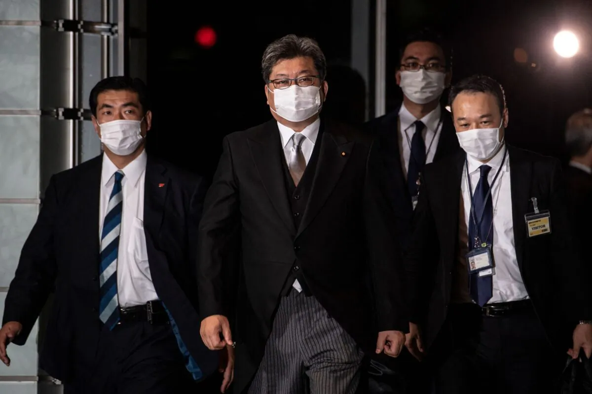 Japan's Economy, Trade and Industry Minister Koichi Hagiuda (C) arrives at the prime minister's office in Tokyo on Oct. 4, 2021. (Philip Fong/AFP via Getty Images)