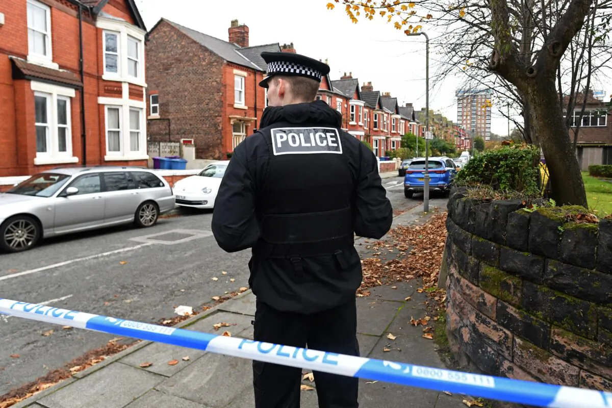 A police officer works inside a cordoned-off area on Rutland Avenue, the place where police have confirmed the passenger of the taxi that later exploded outside the Women's Hospital in Liverpool was picked up, on Nov. 15, 2021. (Paul Ellis/AFP via Getty Images)