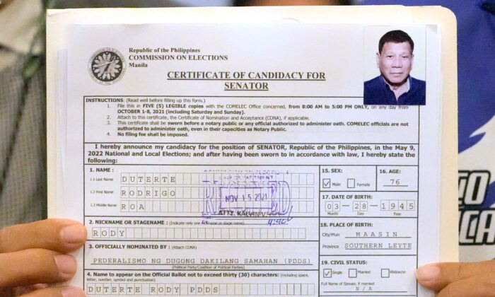 A representative of Philippine President Rodrigo Duterte holds his Certificate of Candidacy for Senator at the Commission on Elections in Manila, Philippines, on Nov. 15, 2021. (Aaron Favila/AP Photo)