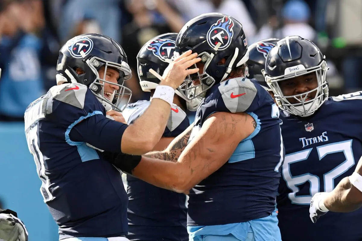Tennessee Titans quarterback Ryan Tannehill (L) celebrates after scoring a touchdown on a 1-yard run against the New Orleans Saints in the first half of an NFL football game in Nashville, Tenn., on Nov. 14, 2021. (Mark Zaleski/AP Photo)