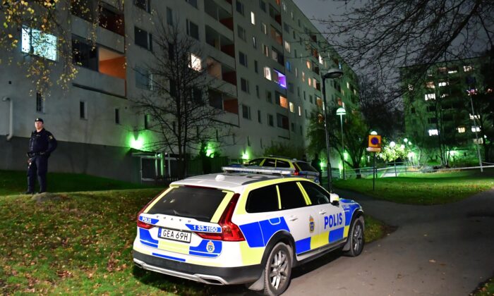 Police outside an apartment block after an incident in Hasselby, northwest Stockholm, Sweden, on Nov. 14, 2021. (Jonas Ekstromer/TT News Agency via AP)