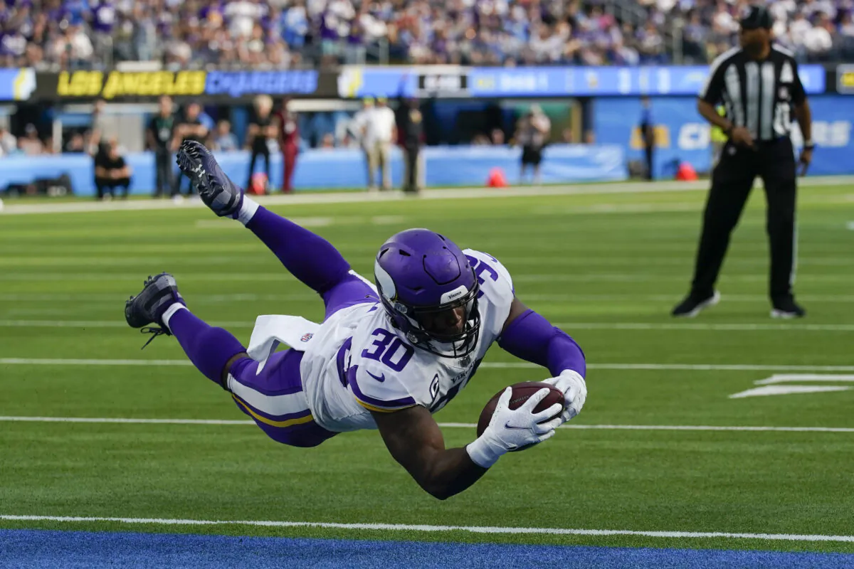 Minnesota Vikings fullback C.J. Ham (30) dives across the goal line on a play that was called back on penalty during the first half of an NFL football game against the Los Angeles Chargers in Inglewood, Calif., on Nov. 14, 2021. (AP Photo/Gregory Bull)