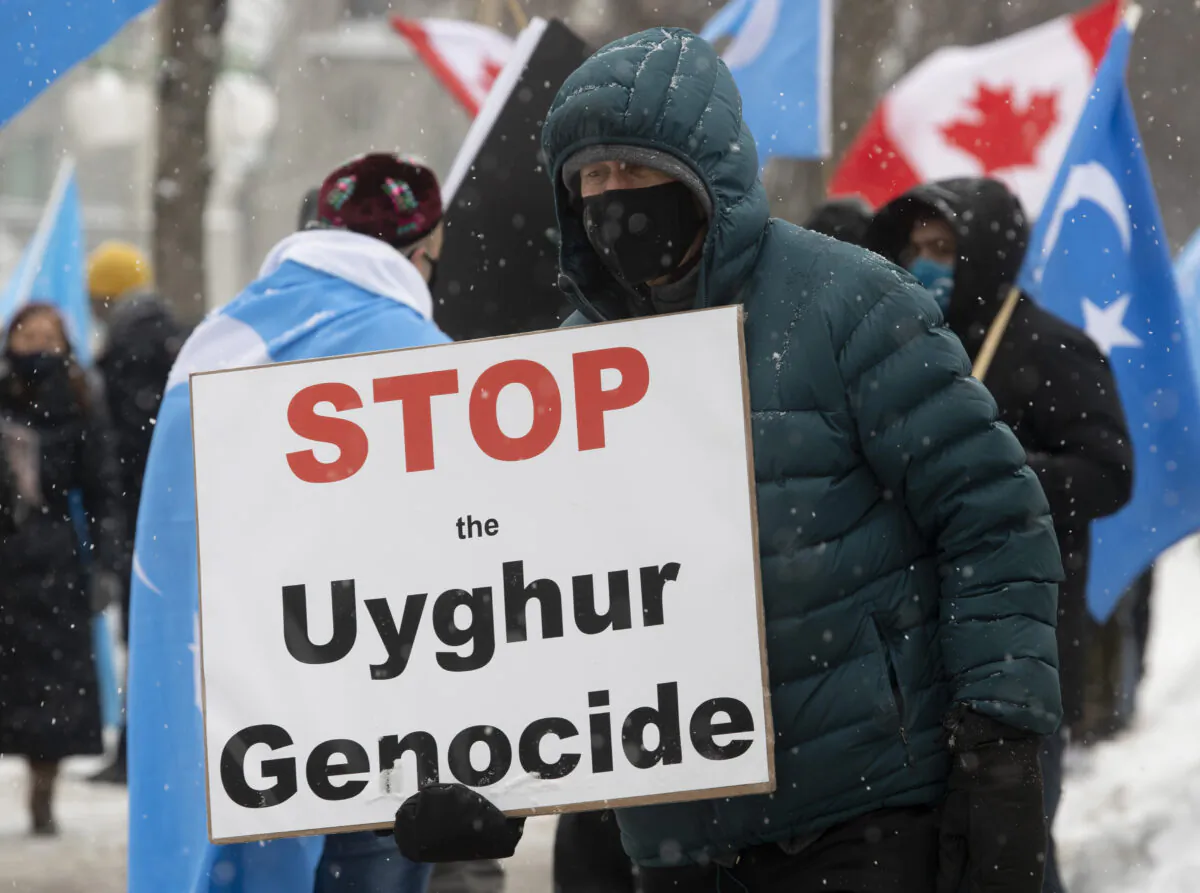 Protesters gather outside the Parliament Buildings in Ottawa on Feb. 22, 2021, as MPs voted on a motion calling on Canada to recognize China's actions against ethnic Muslim Uighurs as genocide. (The Canadian Press/Adrian Wyld)