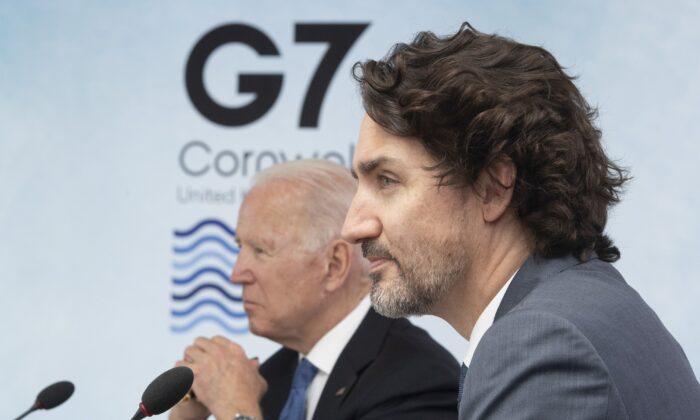 Prime Minister Justin Trudeau and U.S. President Joe Biden listen to opening remarks during a plenary session at the G7 Summit in Carbis Bay, United Kingdom, on June 11, 2021. ( Canadian Press/Adrian Wyld)
