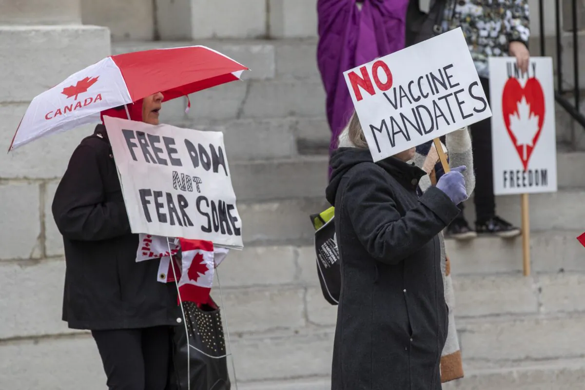 People gather to protest COVID-19 vaccine mandates and masking measures during a rally in Kingston, Ont., on Nov. 14, 2021. (Lars Hagberg/The Canadian Press)