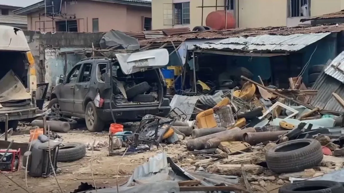 Various of gas cylinders, damaged cars and building at site of gas explosion in Lagos, Nigeria, on Nov. 16, 2021, in a still image from real-time camera footage released by AP. (AP/Screenshot via The Epoch Times)