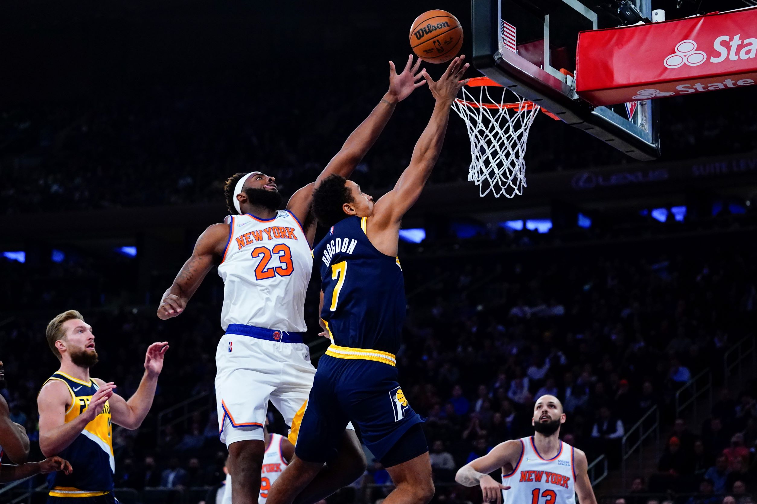 Knicks' Mitchell Robinson (23) blocks a shot by Pacers' Malcolm Brogdon (7)