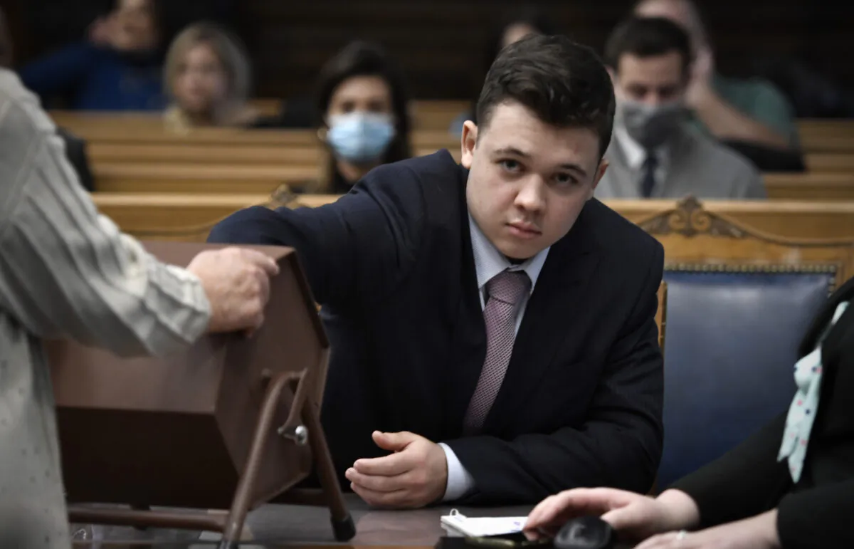 Kyle Rittenhouse pulls numbers of jurors out of a tumbler during his trial at the Kenosha County Courthouse in Kenosha, Wis., on Nov. 16, 2021. (Sean Krajacic/The Kenosha News via AP, Pool)