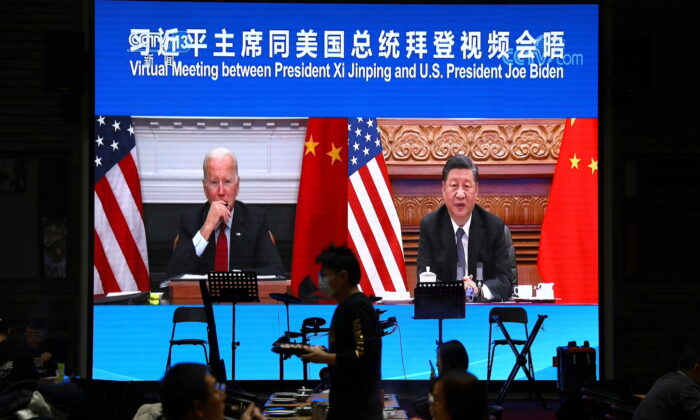 A screen shows Chinese leader Xi Jinping attending a virtual meeting with U.S. President Joe Biden via video link, at a restaurant in Beijing, China, on Nov. 16, 2021. (Tingshu Wang/Reuters)
