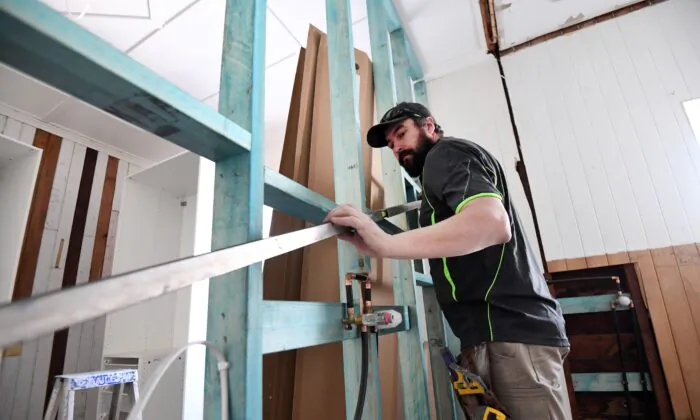 A carpenter is seen working on a house renovation in Brisbane, Australia, June 4, 2020. (AAP Image/Dan Peled)