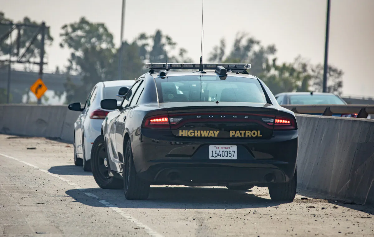 A California Highway Patrol officer pulls someone over on the 405 Freeway in Los Angeles, Calif., on Nov. 8, 2021. (John Fredricks/The Epoch Times)