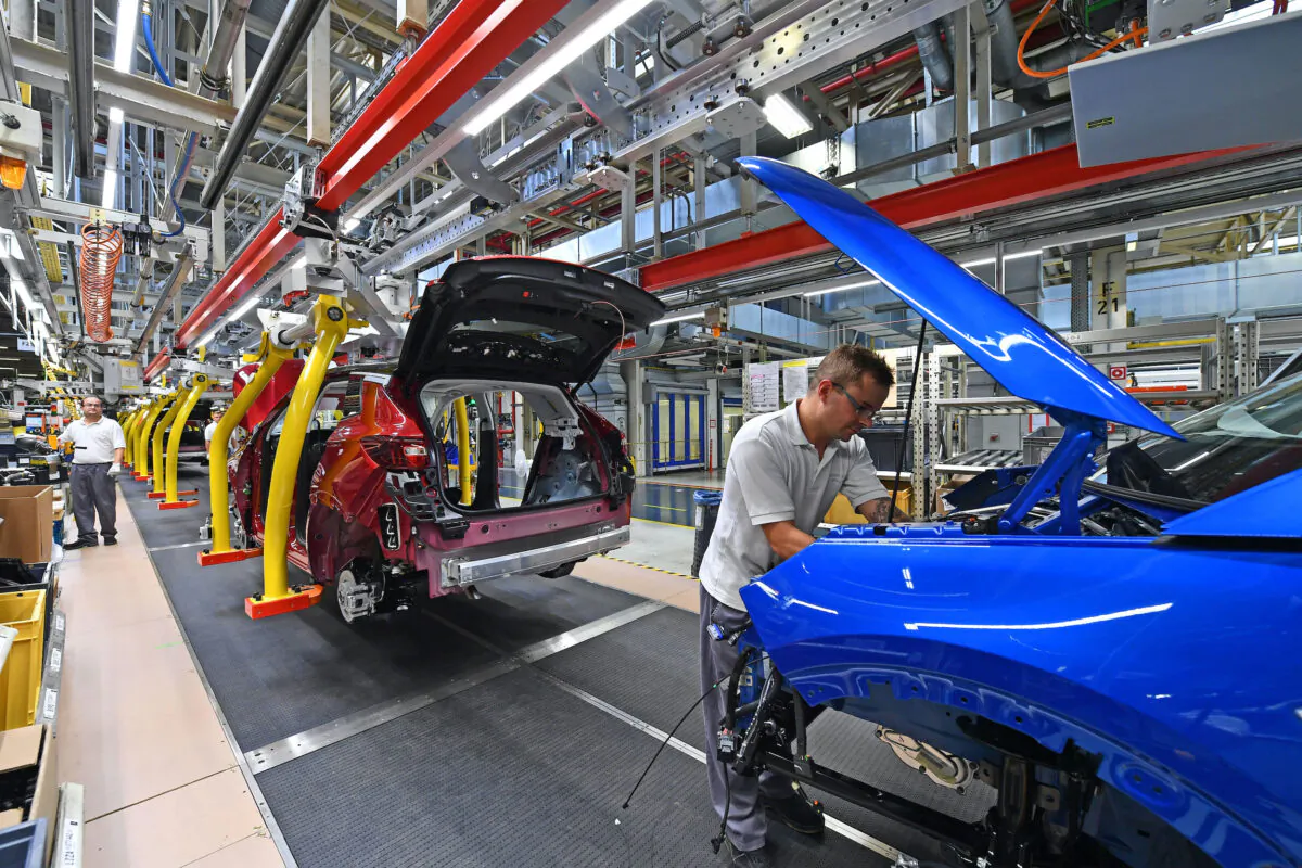 A man works on the assembling of an Opel "Grandland X" SUV car at Opel's plant in Eisenach, eastern Germany, on Aug. 28, 2019. (Martin Schutt /DPA/AFP via Getty Images)