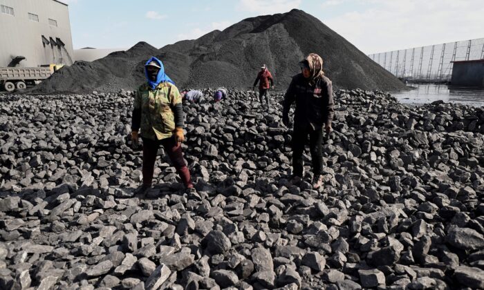 Workers sort coal near a coal mine in Datong, China's northern Shanxi Province on Nov. 3, 2021. (Noel Celis/AFP via Getty Images)