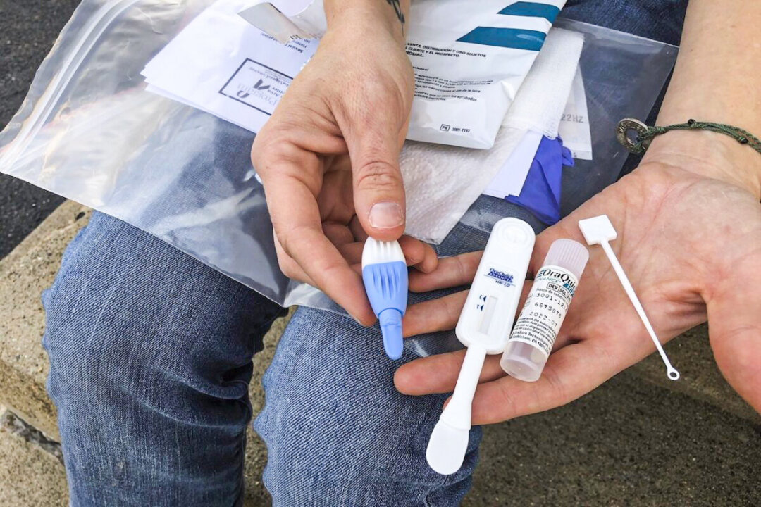 A person holds an HIV testing kit in Charleston, W.Va., on March 9, 2021. (John Raby/AP Photo)
