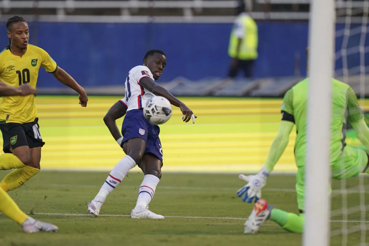 United States' Tim Weah (C) scores his side's opening goal against Jamaica during a qualifying soccer match for the FIFA World Cup Qatar 2022 in Kingston, Jamaica, on Nov. 16, 2021. (Fernando Llano/AP Photo)