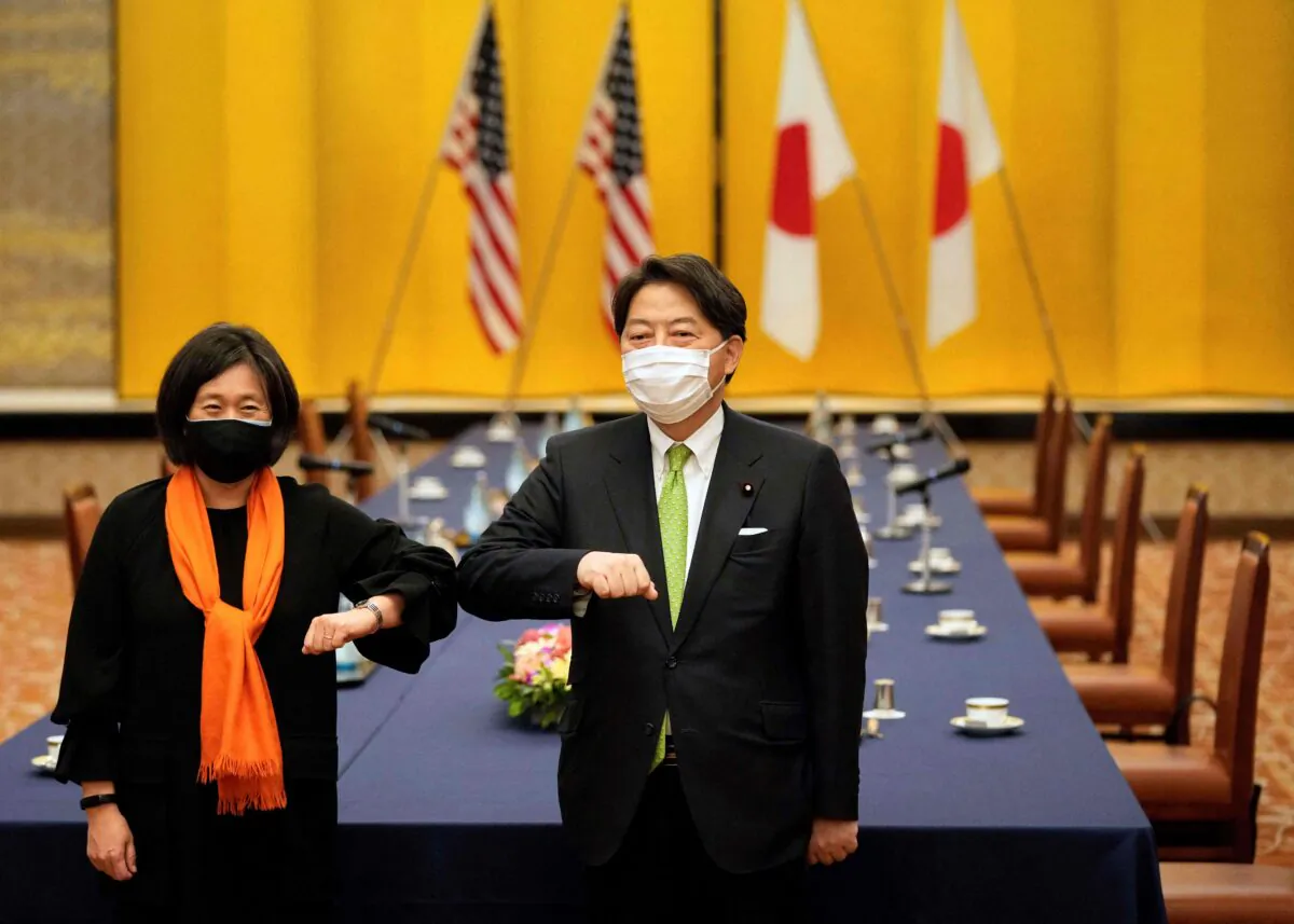 US Trade Representative Katherine Tai (L) elbow bumps with Japan's Foreign Minister Yoshimasa Hayashi (R) ahead of their meeting at the Iikura Guest House in Tokyo, on Nov. 17, 2021. (Franck Robichon/POOL/AFP via Getty Images)